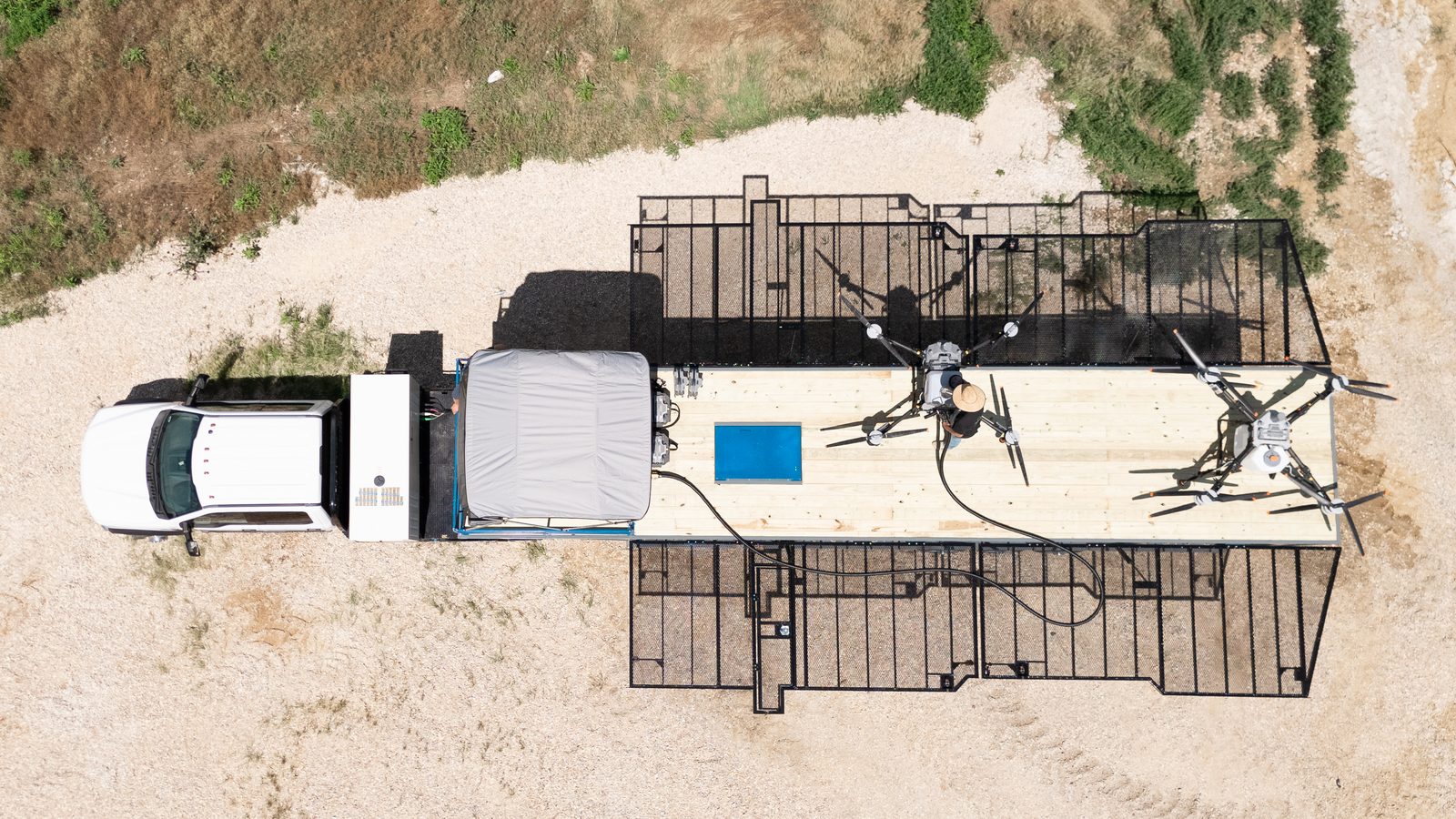 Aerial view of Iowa crop fields with a Vertical Ag rig staged at the edge